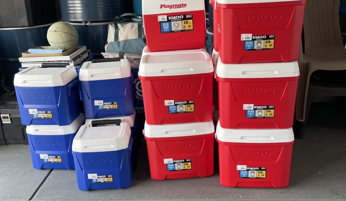 A bunch of red and blue boxes kept in front of barrels